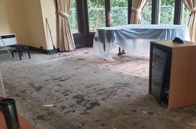 During preparation - existing coverings removed and subfloor exposed.